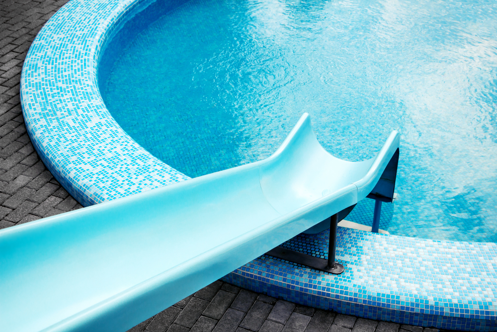 Round,Shaped,Swimming,Pool,With,Blue,Water,Slide,For,Background,